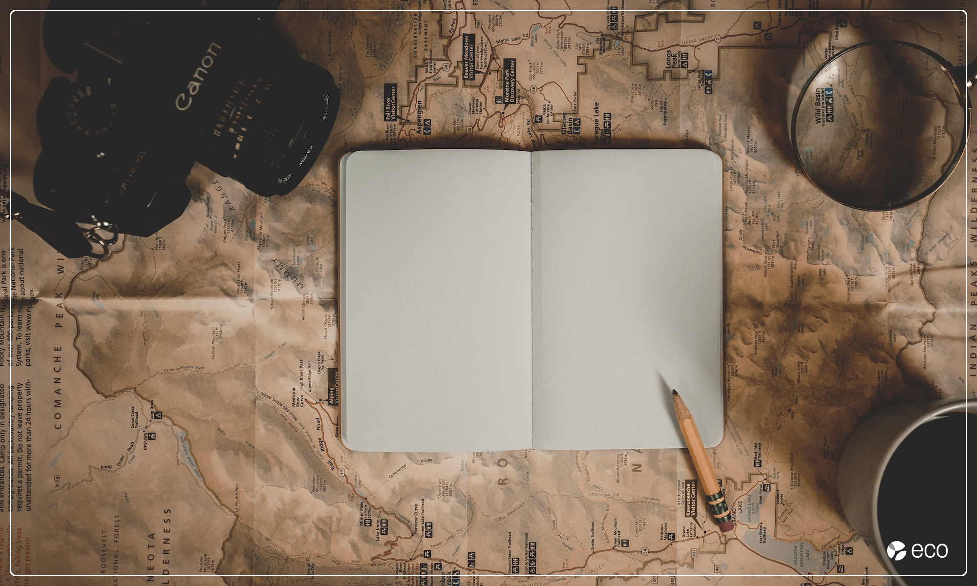 Blank journal with map and camera